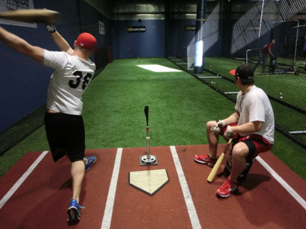 two athletes at batting practice